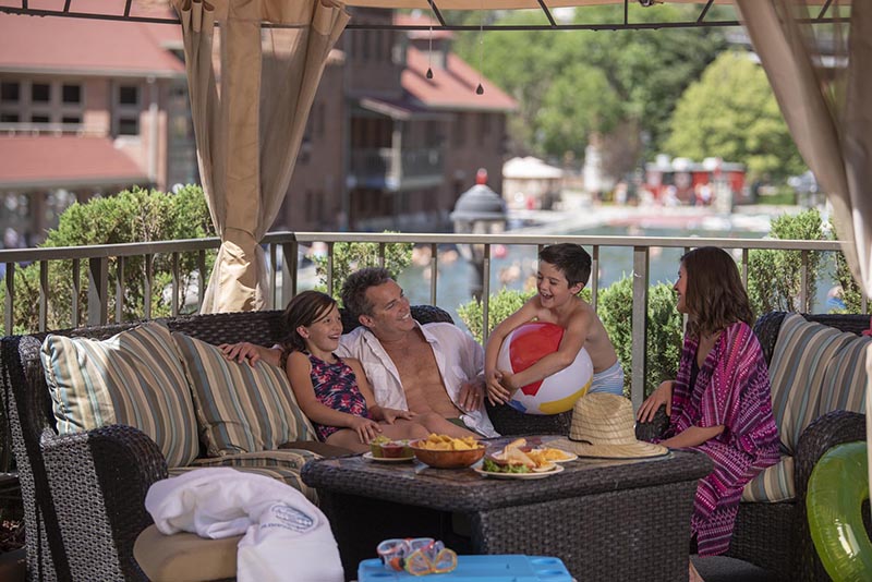family with food sits under a cabana at the glenwood hot springs pool